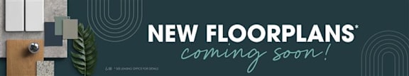 A sign announces "New Floorplans Coming Soon!" in a modern office setting.