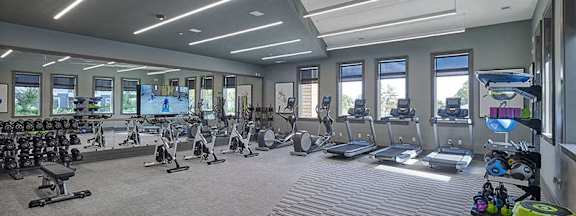 A spacious gym with a variety of equipment and a large mirror on the wall. at Madison Ellis Preserve, Newtown Square, PA