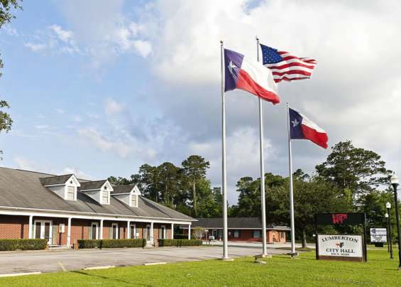 A building with a sign that says "Hillcrest" in front of it.