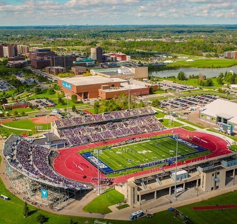 an aerial view of a football stadium and a city