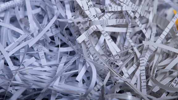 A pile of shredded paper with visible text.