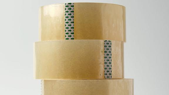 A stack of three brown paper rolls with green and white stripes.