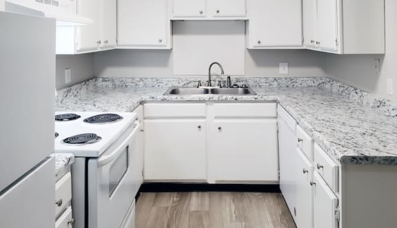Kitchen with White Furniture and Appliances at Woodland Villas Apartments in Jasper, AL