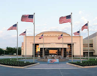 The building is surrounded by a lot of American flags.