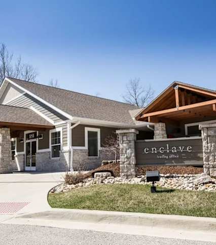 The image shows a building with the name "enclave" on it.