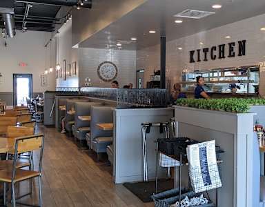 A restaurant with a kitchen area in the background.