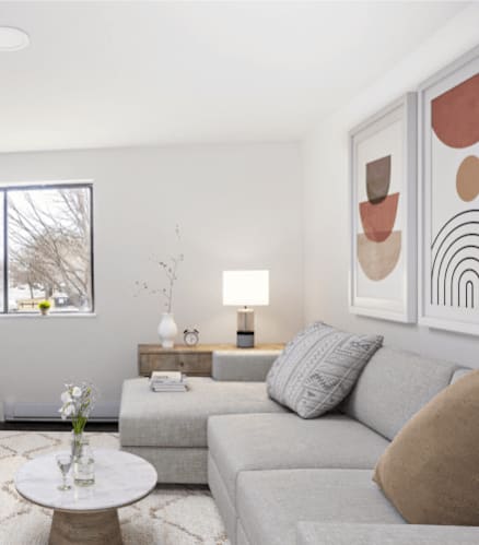 a living room with a gray couch and a television
