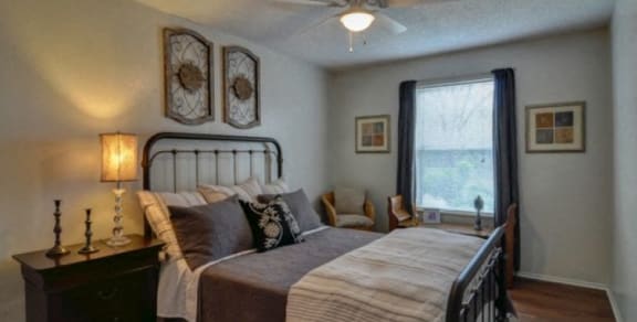 a bedroom with a large bed and a ceiling fan