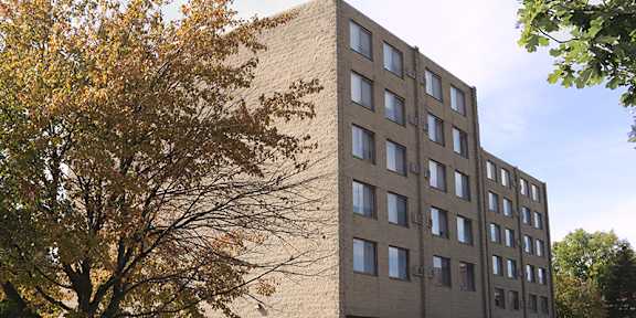 A large building with a parking lot in front.