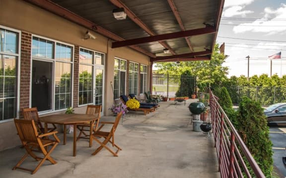 a patio with tables and chairs at The Lofts at Elk Terminal Apartments , Buffalo, NY