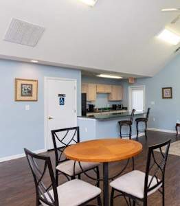 A living room with a dining table and chairs.