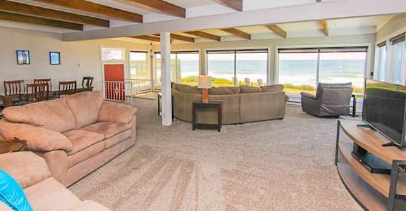 A living room with a couch, a chair, and a television.