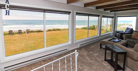 A living room with a view of the beach.