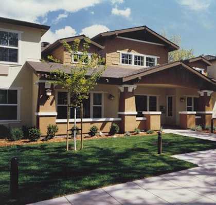 a large house with a sidewalk in front of it