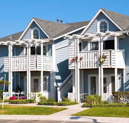 a row of blue and white houses on a street