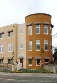 people sitting on benches in front of a tall building