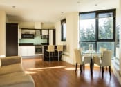 Thumbnail 3 of 6 - a living room and dining room with a table and chairs