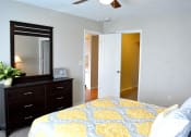 Thumbnail 12 of 22 - Bedroom with queen size bed, dresser, mirror, and walk-in closet