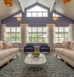 A living room with a large rug and two couches.