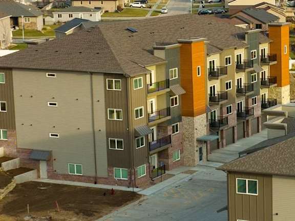 Apartment buildings with parking spaces in front.