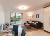 Thumbnail 6 of 6 - a living room and dining room with a couch and a table