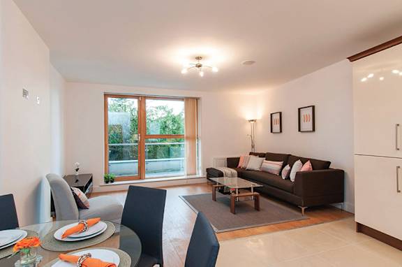 a living room and dining room with a couch and a table