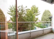 Thumbnail 3 of 6 - a balcony with a view of a courtyard and trees