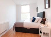 Thumbnail 4 of 6 - a bedroom with a bed and a window