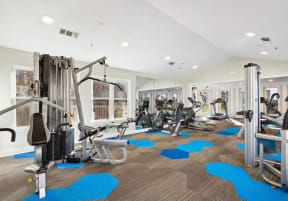 a gym with cardio equipment and weights in a building