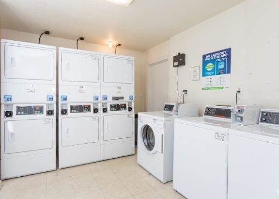 A row of washing machines in a laundromat.
