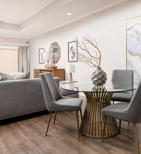 a living room with blue furniture and a ceiling fan
