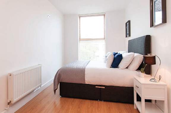 a bedroom with a bed and a window