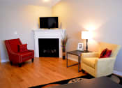 Thumbnail 18 of 22 - Living room with chairs next to fireplace