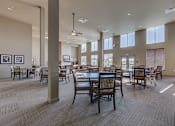 Thumbnail 5 of 25 - Clubhouse chairs and tables at VINTAGE AT LAKEWOOD SENIORS Apartments, Marysville, WA
