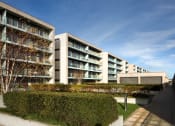 Thumbnail 1 of 5 - an apartment building with a courtyard and a blue sky