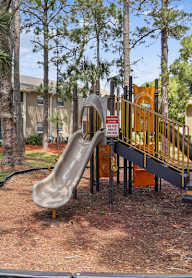 A playground with a slide and a no-slide sign.