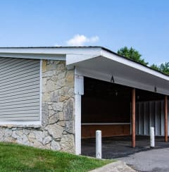 a stone building with a garage with roller shutter doors