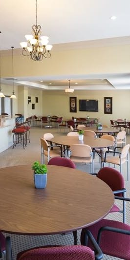 a dining room and kitchen with tables and chairs