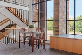 a dining room with a table and chairs and a large window