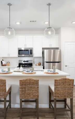 A modern kitchen with a dining table set for four.