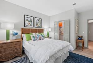 A bedroom with a bed, nightstand, and two lamps.