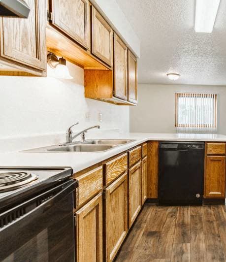 Grand Forks, ND Chandler 1802 | a kitchen with a stove and a sink and a refrigerator Grand Forks, ND Chandler 1802 | a kitchen with a stove and a sink and a refrigerator