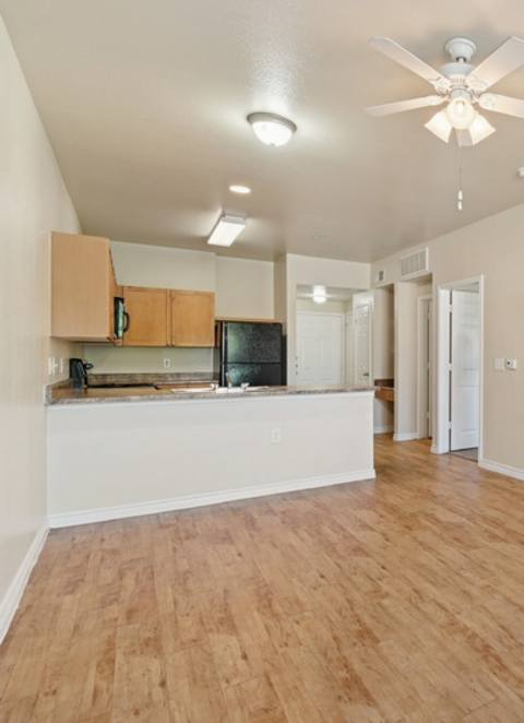 A kitchen with a sink, stove, and cabinets.