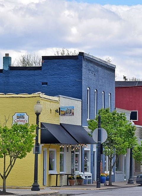 a small town street with a car parked on the side of the road at Ridgeview, Fortville, Indiana