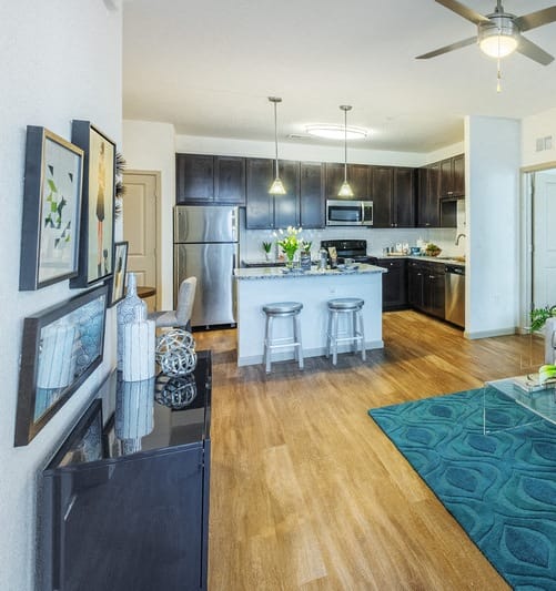 a living room and kitchen with a couch and a table