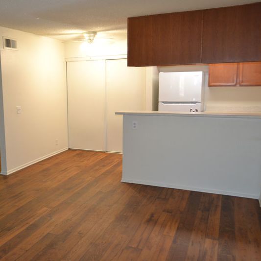 A room with wooden floors and white walls.