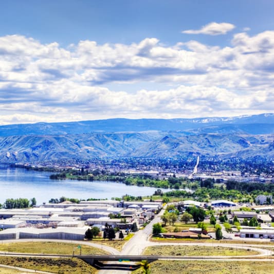photo of mountains and a cloudy sky with the city below