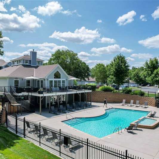 A large house with a pool in the backyard.