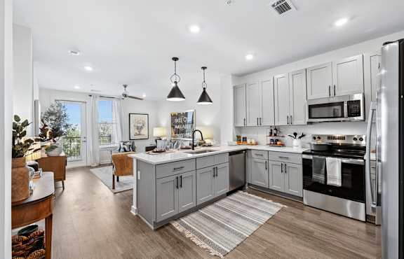 Furnished open living room and kitchen at Encore at Brentwood apartments in Brentwood, Tennessee.