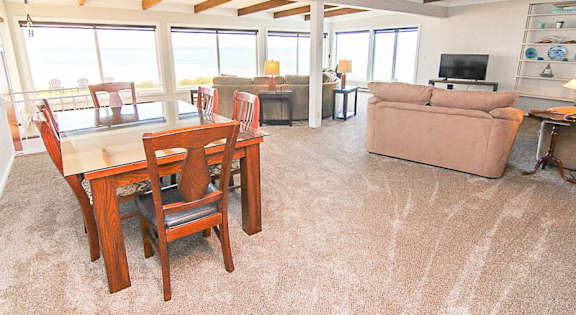A living room with a dining table and chairs.